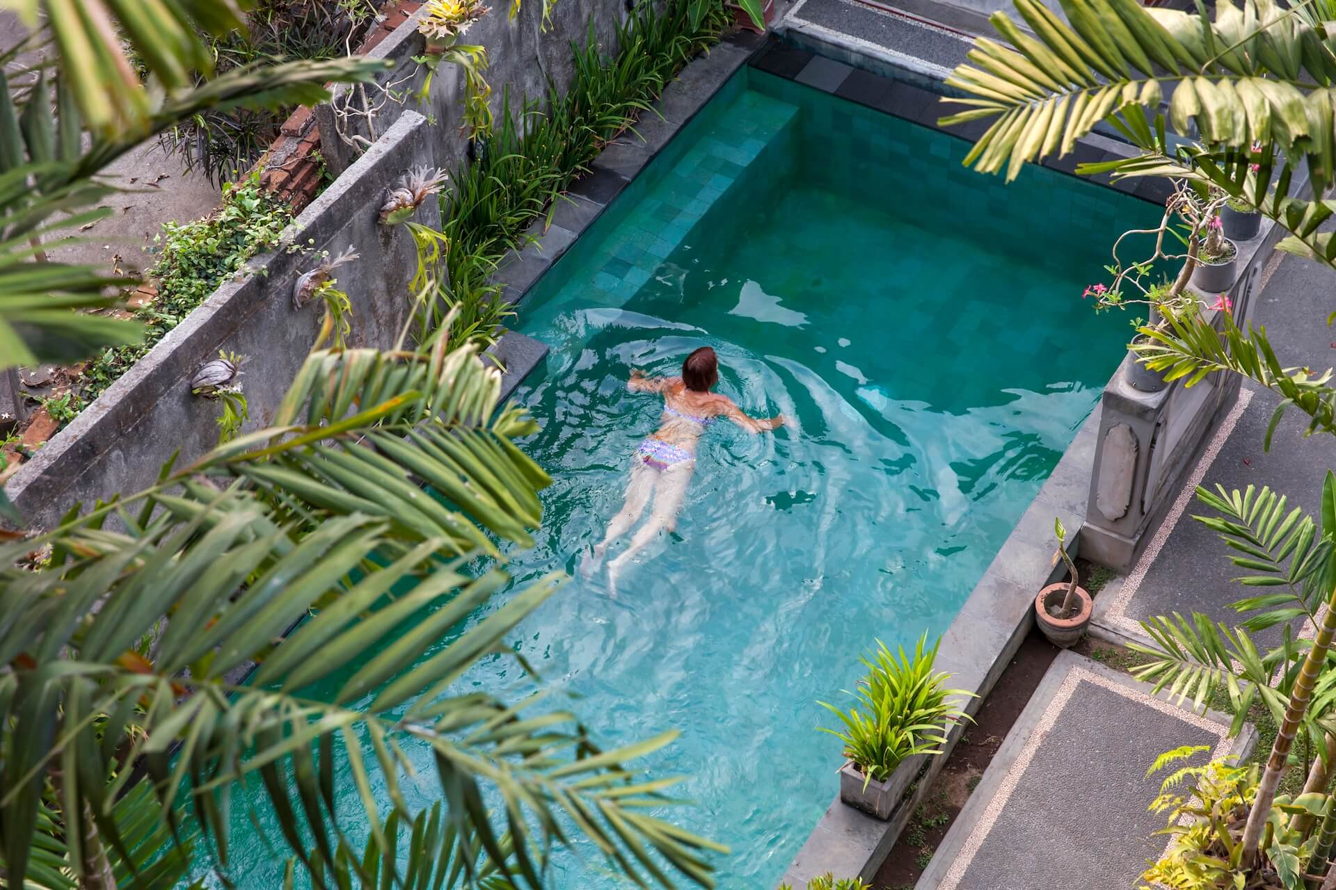 young-woman-swimming-in-the-pool-in-ubud-bali-vi-2022-07-11-03-48-14-utc.jpg